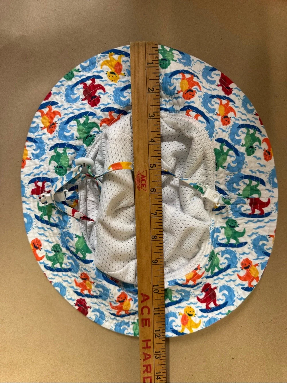 Amazon Kids' White Bucket Hat with Multicolor Surfing Dinosaurs